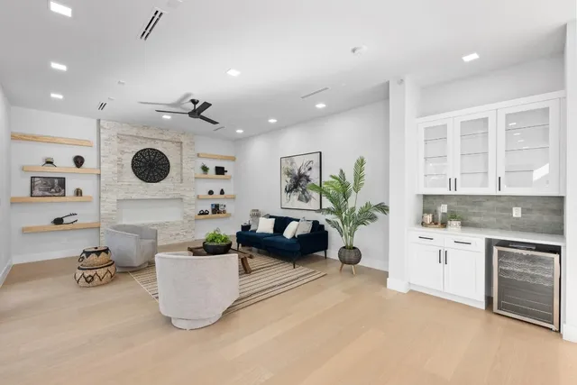a living room with furniture a chandelier and a large window
