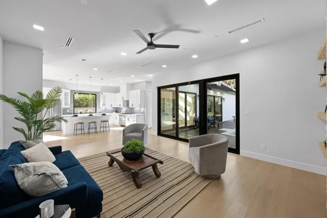 a living room with furniture and wooden floor