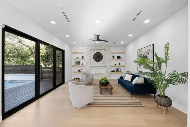 a living room with furniture potted plant and a large window