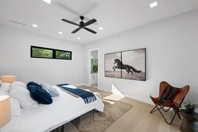 a bedroom with a bed and a painting on the wall