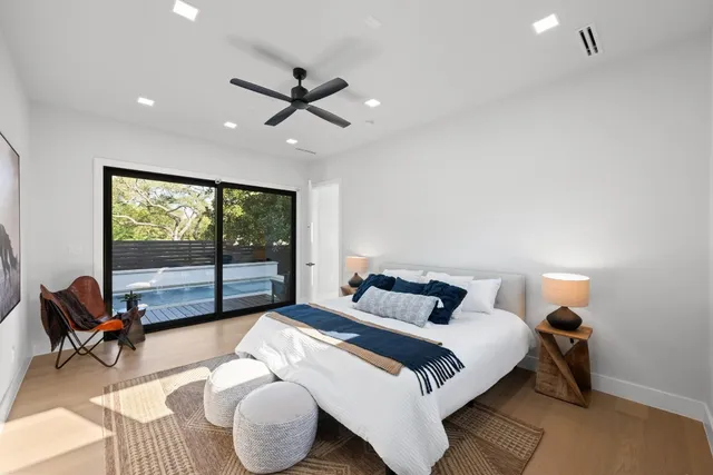 a bedroom with a bed and glass window