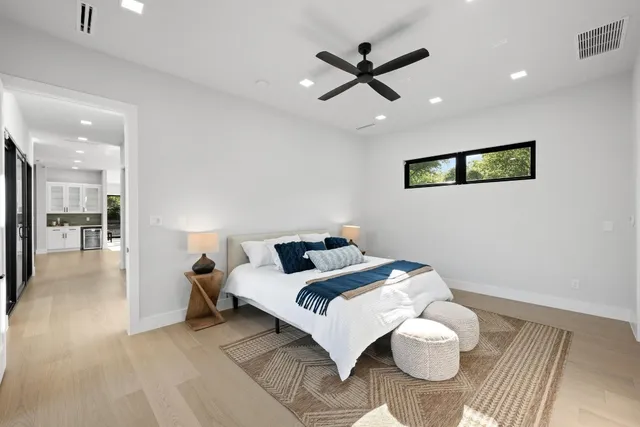 a living room with furniture and a view of kitchen