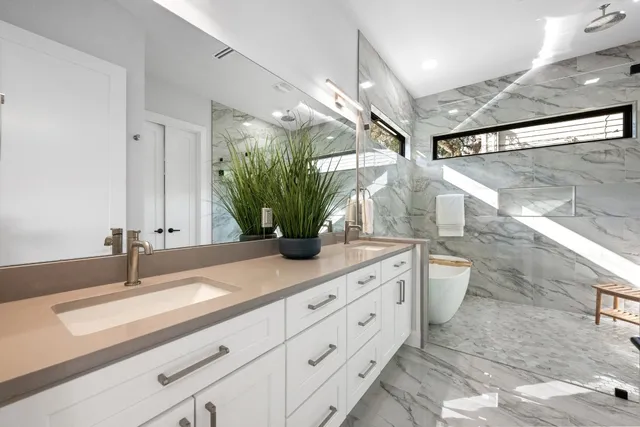a bathroom with a granite countertop sink a toilet and a mirror