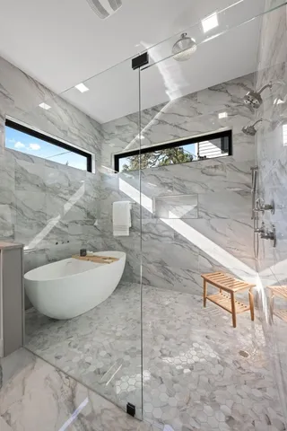 a bathroom with a sink a mirror and a shower