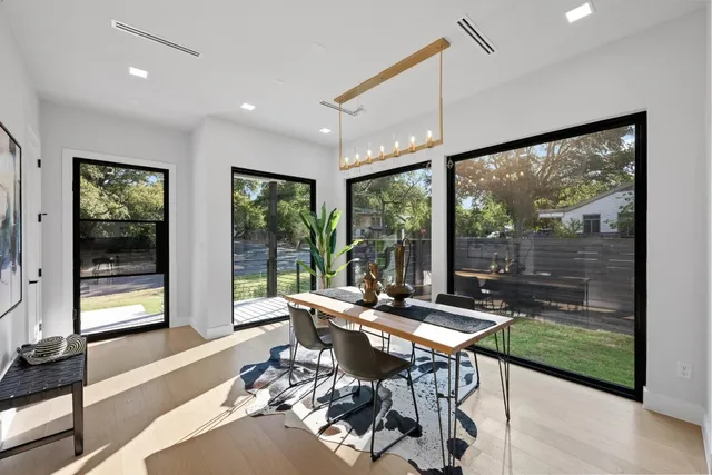 a living room with furniture and large windows