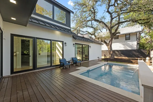 a swimming pool with outdoor seating and yard