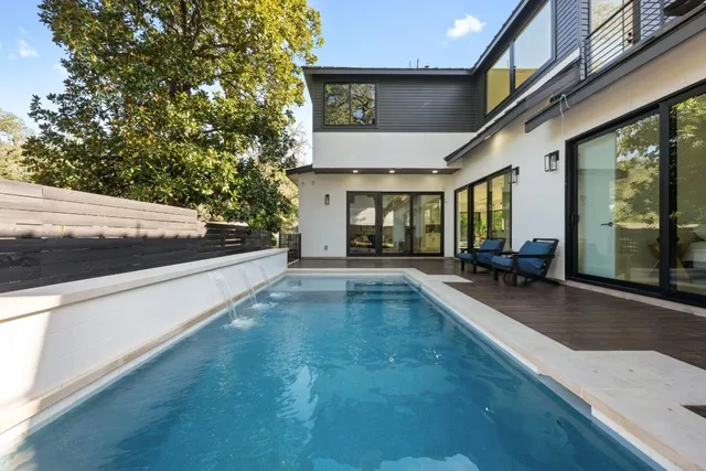 a view of swimming pool with outdoor seating