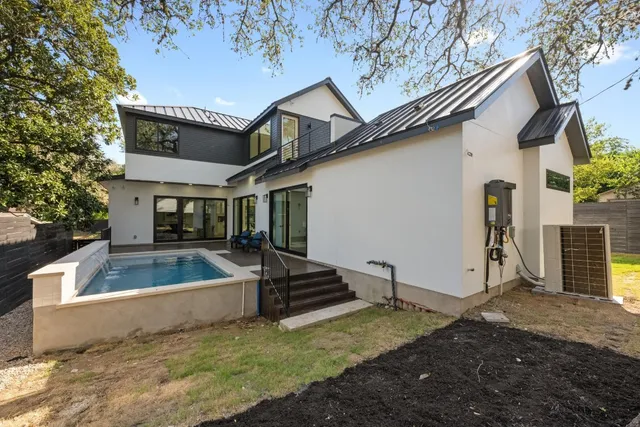 a view of a house with pool and a yard