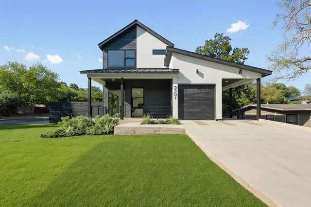 a view of a house with a yard patio and a garden