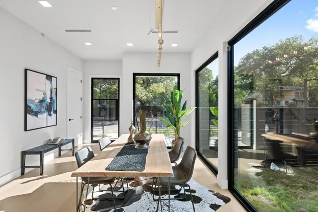 a living room with furniture and large windows
