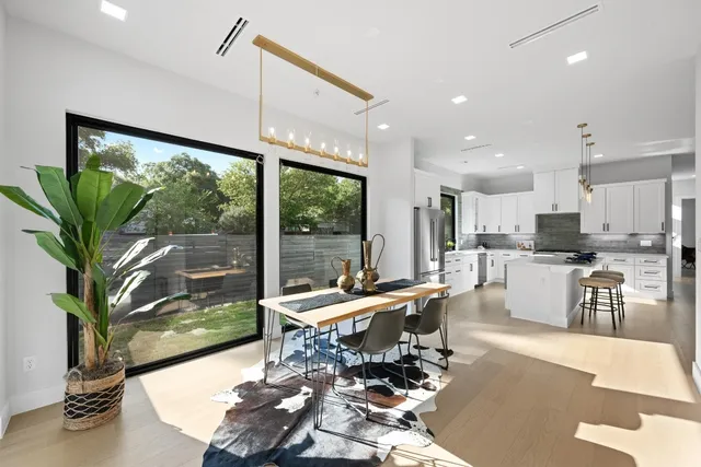 a outdoor kitchen with a large window and dining table