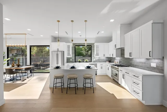 a large kitchen with a large counter top furniture a sink and cabinets