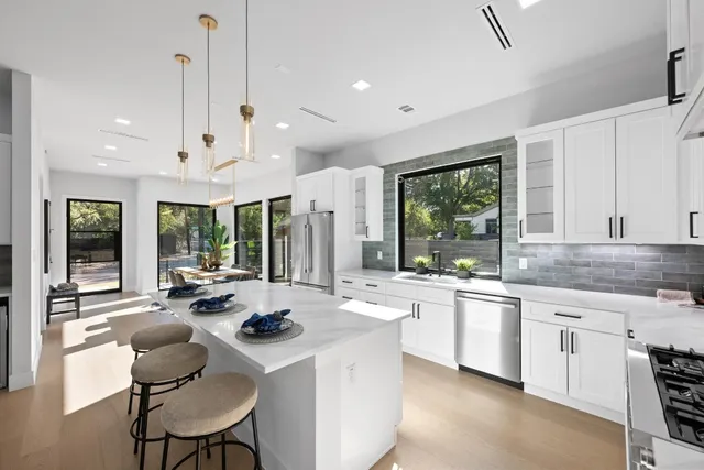 a kitchen with sink stove and living room