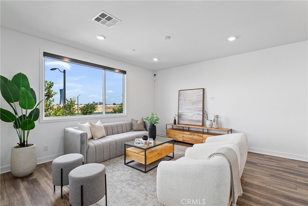 303 Lodestar Tustin, CA 92782 - Photo 11 of 37 a living room with furniture and a potted plant