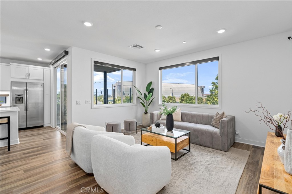 303 Lodestar Tustin, CA 92782 - Photo 12 of 37 a living room with furniture and a large window