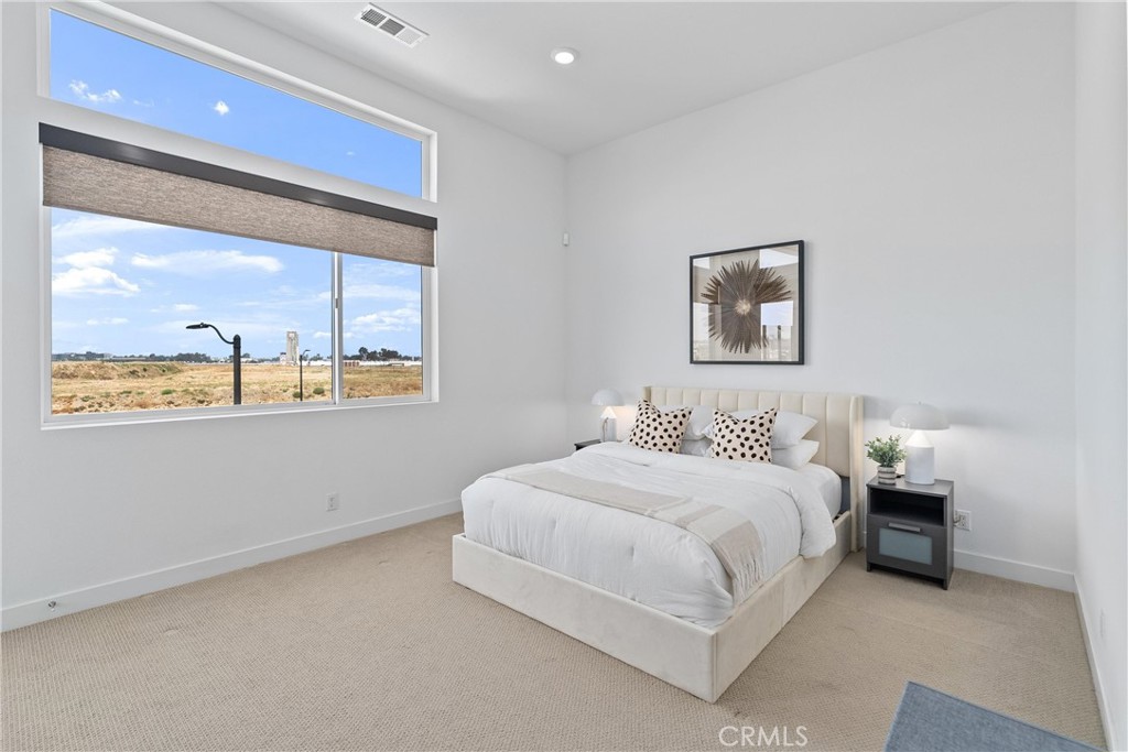 303 Lodestar Tustin, CA 92782 - Photo 18 of 37 a bedroom with a bed and window