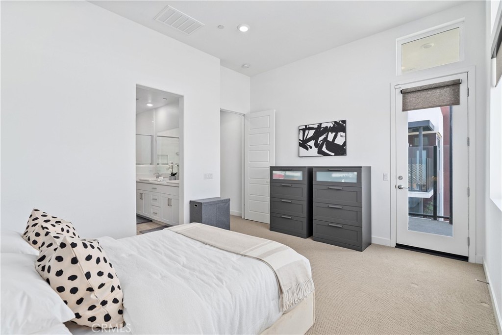 303 Lodestar Tustin, CA 92782 - Photo 19 of 37 a bedroom with a bed and a cabinets