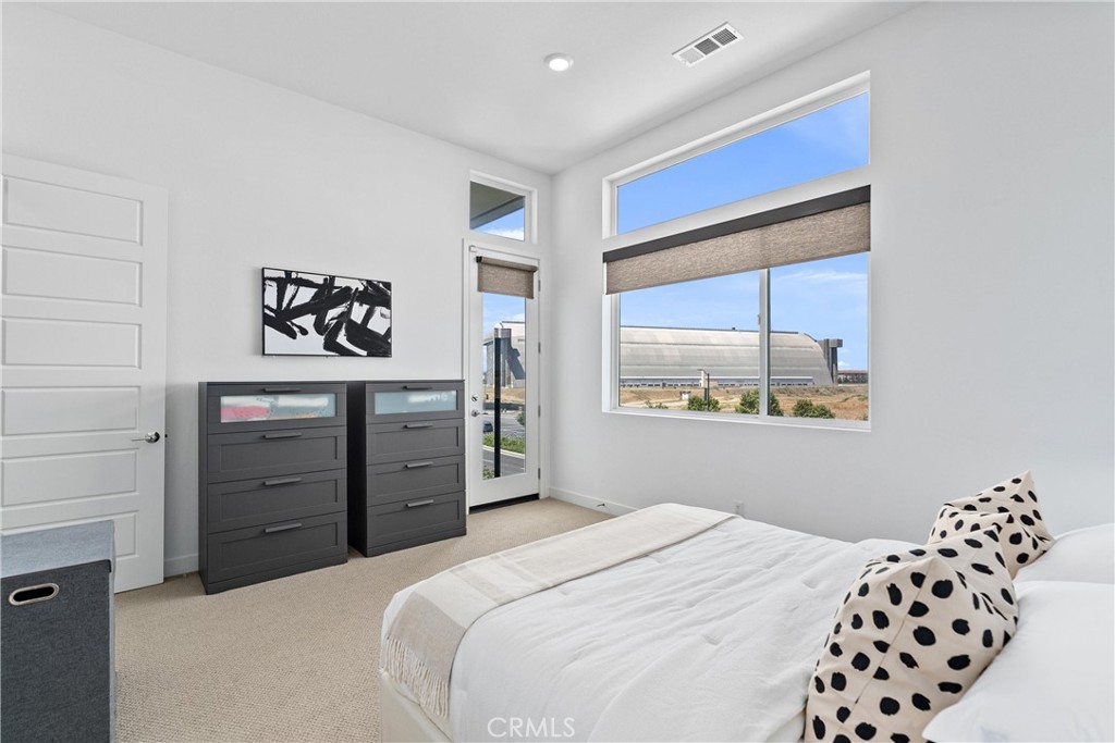 303 Lodestar Tustin, CA 92782 - Photo 20 of 37 a bedroom with a bed and a window