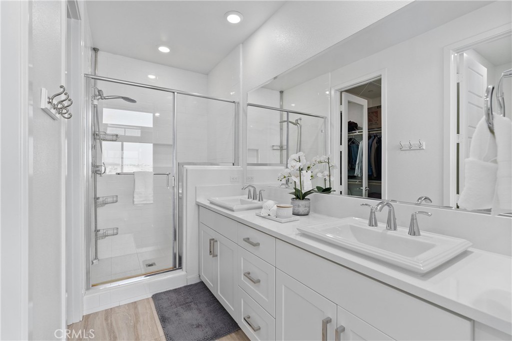 303 Lodestar Tustin, CA 92782 - Photo 22 of 37 a bathroom with a shower sink and mirror