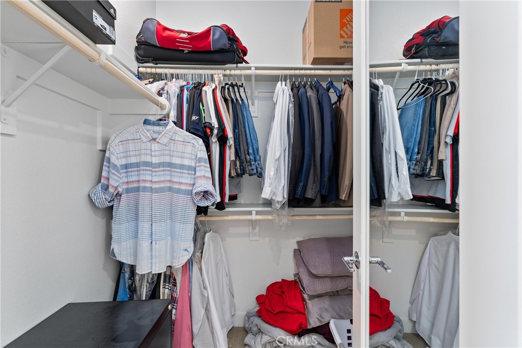 303 Lodestar Tustin, CA 92782 - Photo 23 of 37 a view of walk in closet with clothes and shoes
