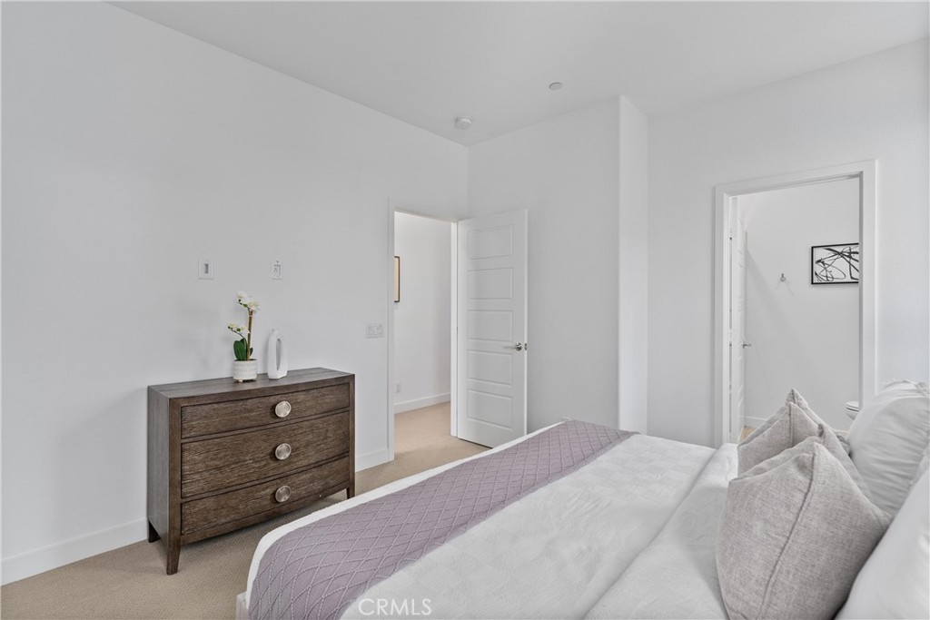303 Lodestar Tustin, CA 92782 - Photo 25 of 37 a bedroom with a bed and a dresser