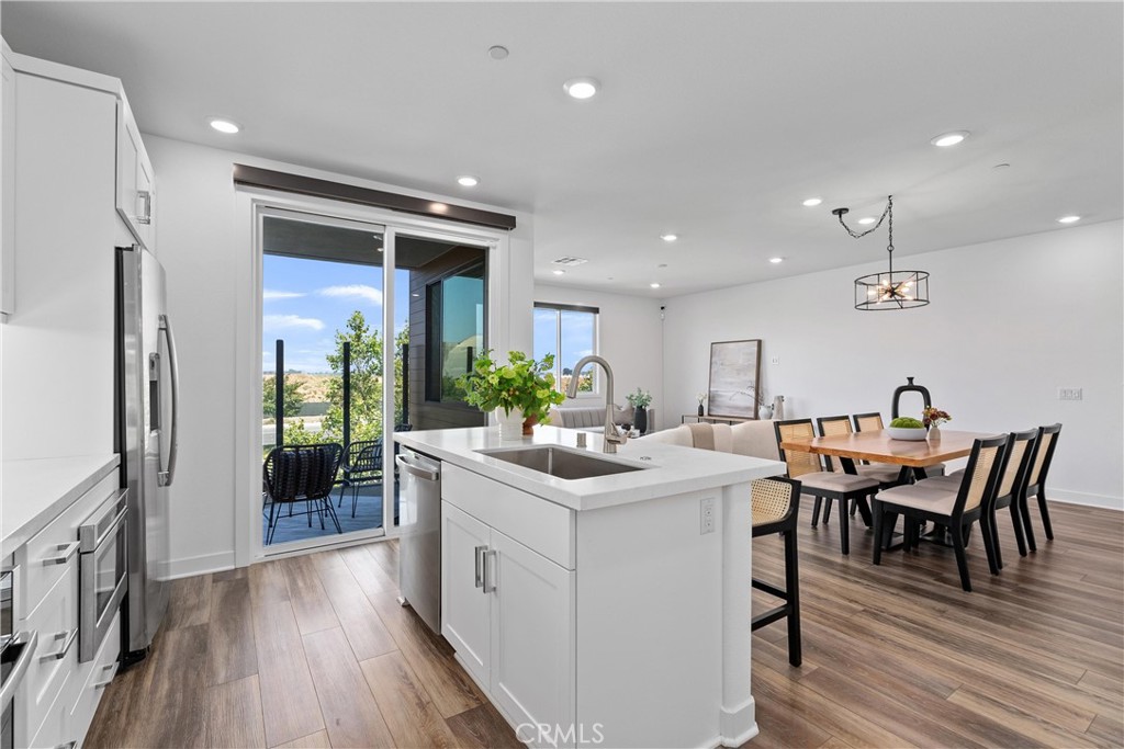 303 Lodestar Tustin, CA 92782 - Photo 10 of 37 a view of a dining room with furniture and wooden floor