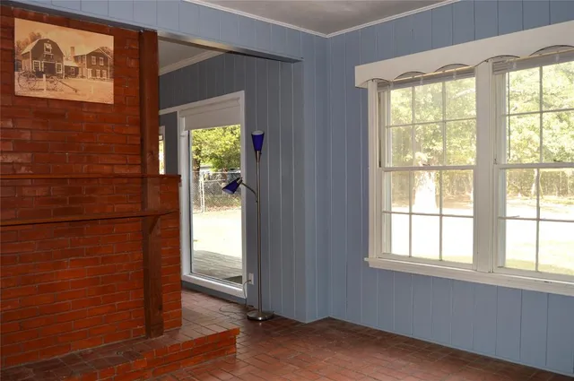 a view of a livingroom with a ceiling fan and window