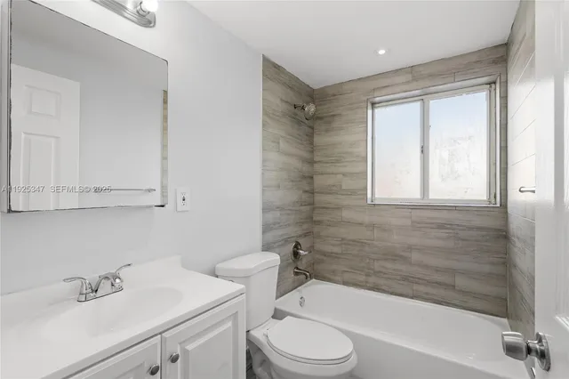 a bathroom with a sink a toilet and a bathtub