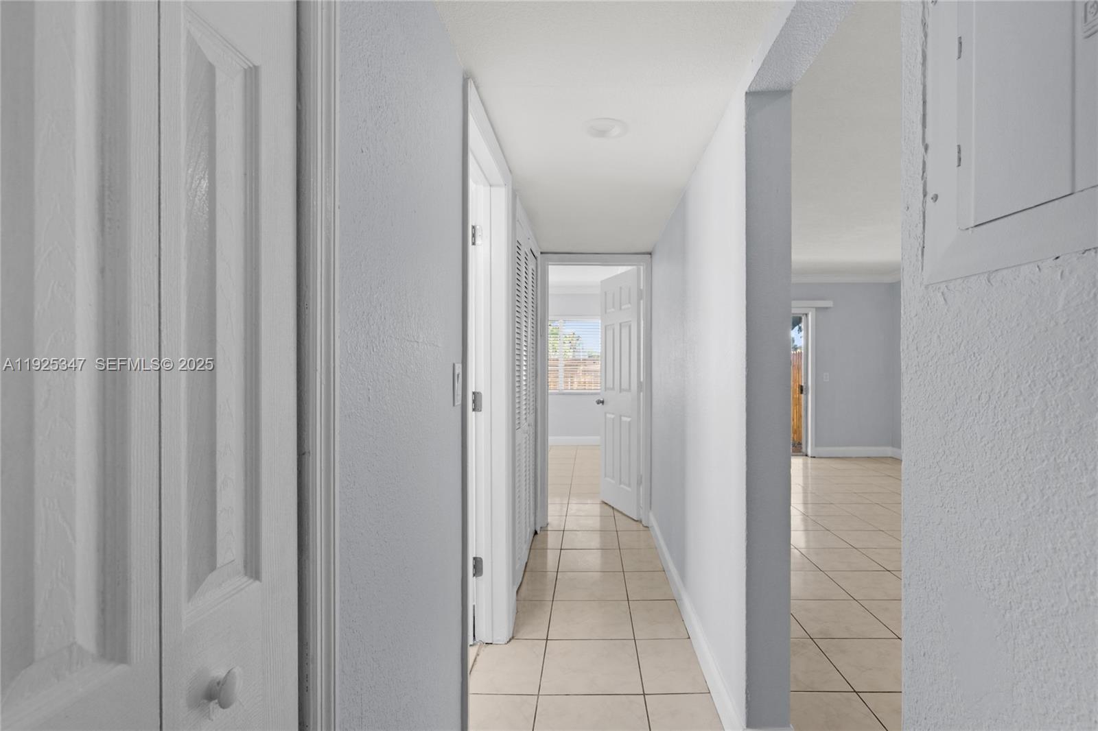 980 Northeast 170th Street, Unit 118 North Miami Beach, FL 33162 - Photo 15 of 32 a view of a hallway