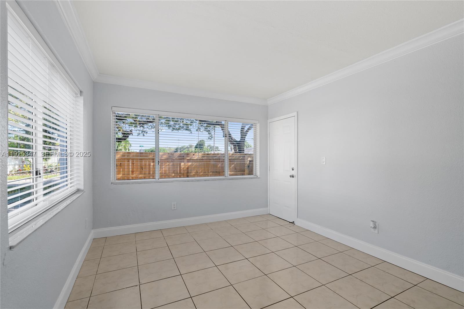 980 Northeast 170th Street, Unit 118 North Miami Beach, FL 33162 - Photo 18 of 32 a view of an empty room with a window