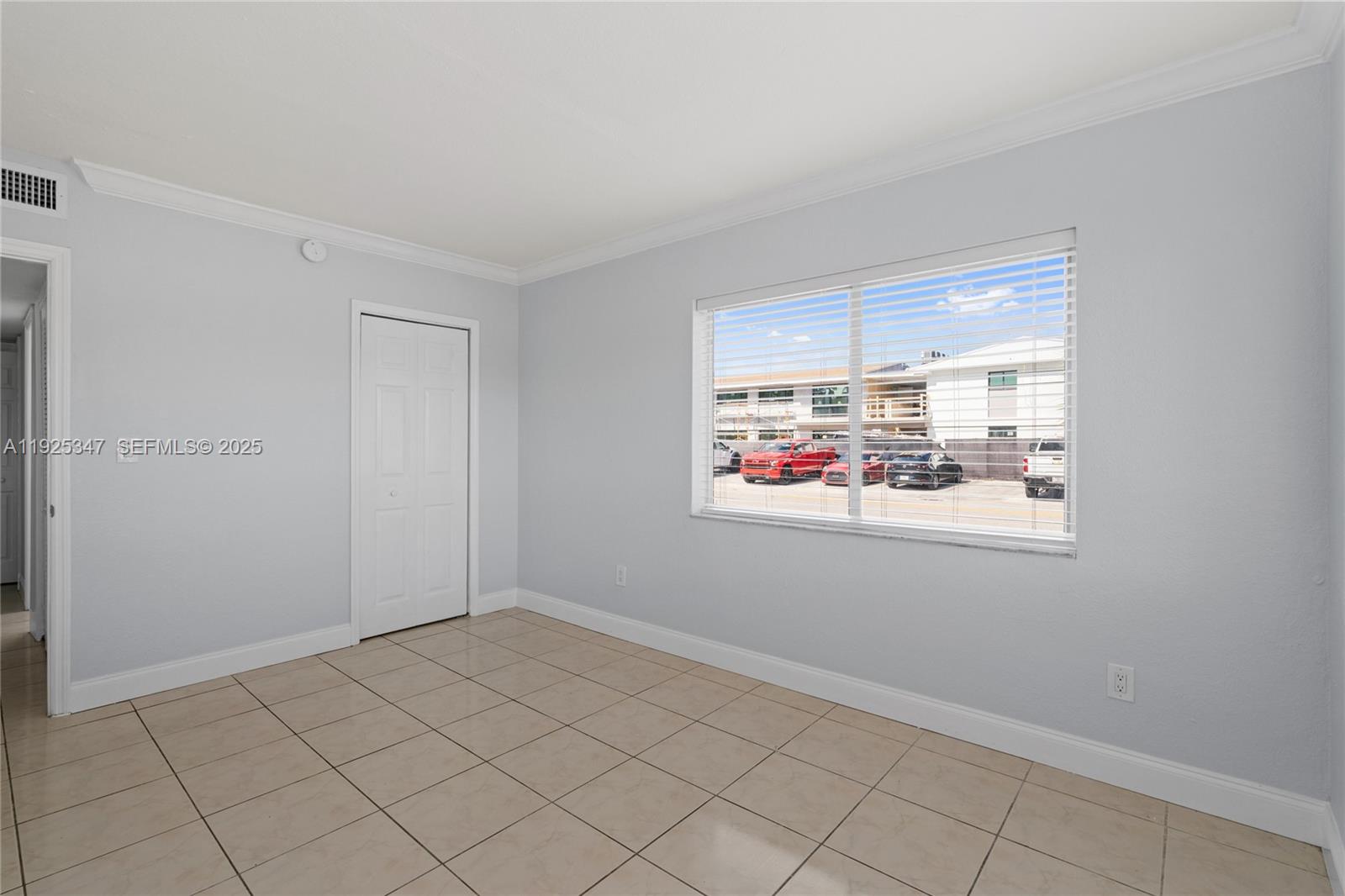 980 Northeast 170th Street, Unit 118 North Miami Beach, FL 33162 - Photo 21 of 32 a view of an empty room and window