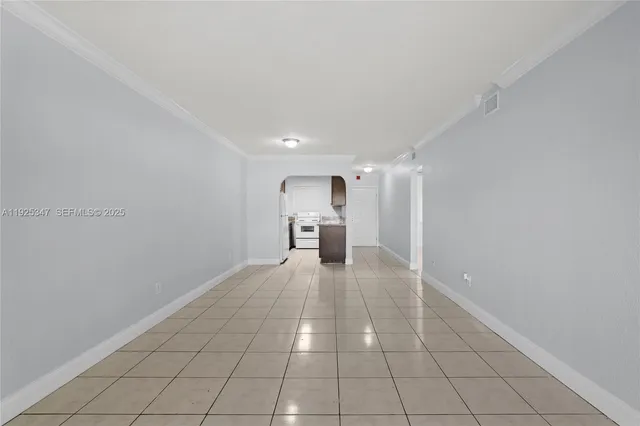 a view of a kitchen with a sink and a refrigerator