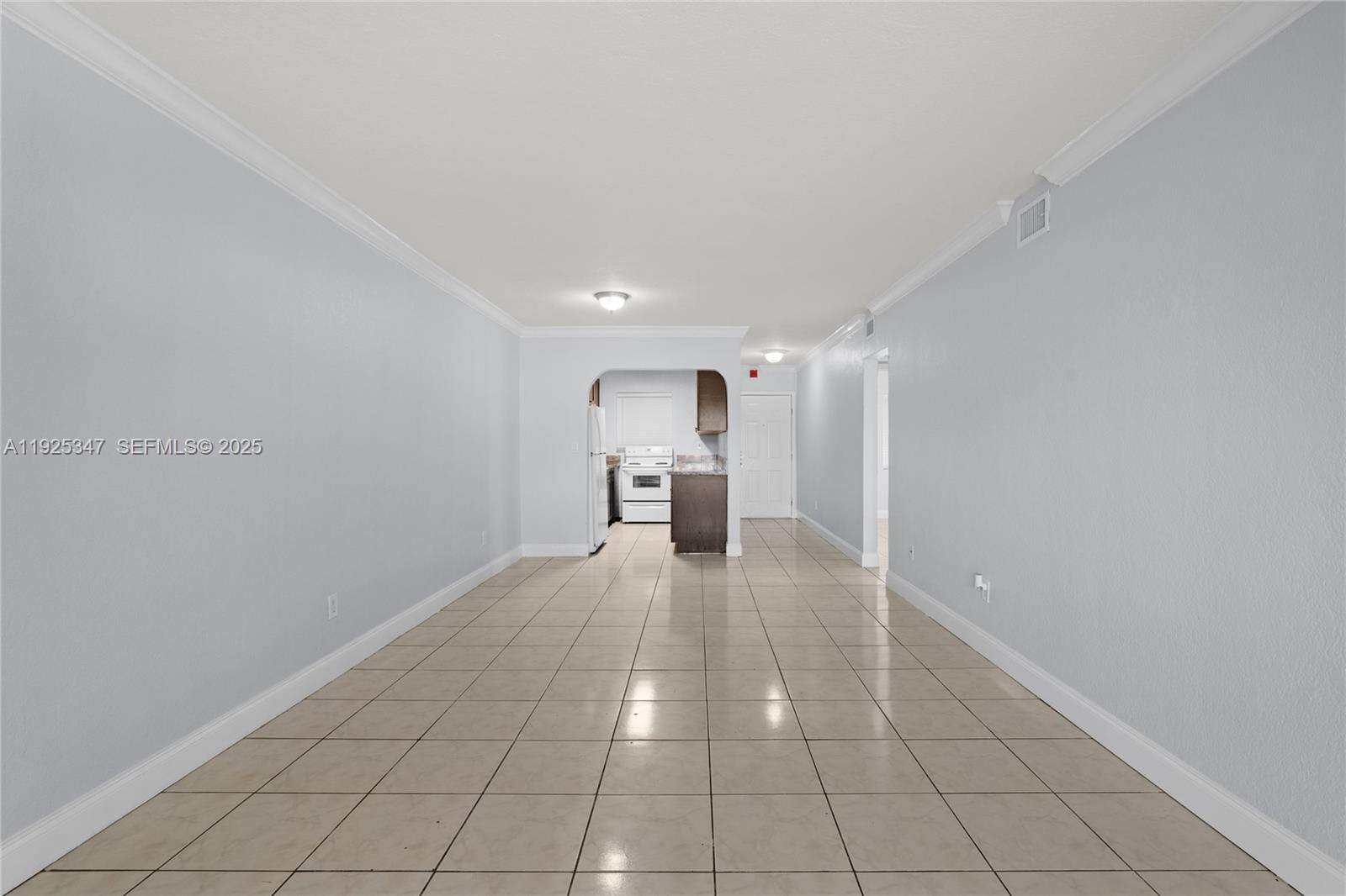 980 Northeast 170th Street, Unit 118 North Miami Beach, FL 33162 - Photo 7 of 32 a view of a kitchen with a sink and a refrigerator