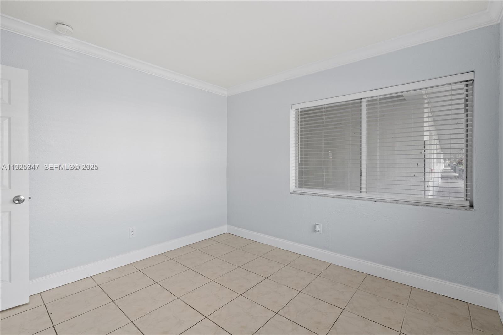 980 Northeast 170th Street, Unit 118 North Miami Beach, FL 33162 - Photo 10 of 32 a view of a room that has a window in it