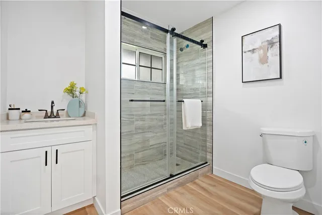 a bathroom with a shower a toilet and a sink