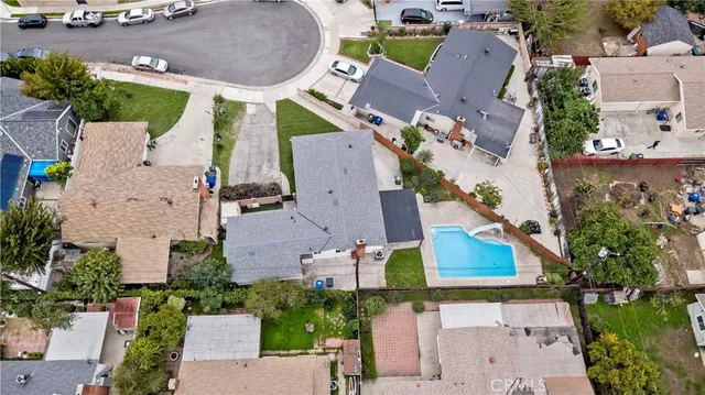 an aerial view of a house with a swimming pool