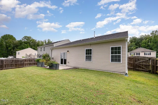 a view of a house with backyard and sitting area
