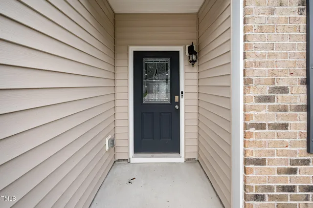a view of front door with wooden door