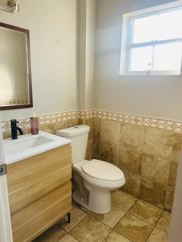 a bathroom with a sink a toilet and a mirror