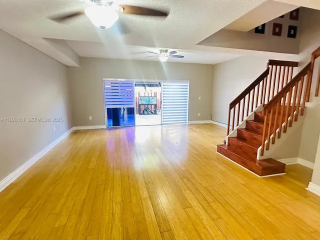 a view of livingroom with wooden floor and stairs