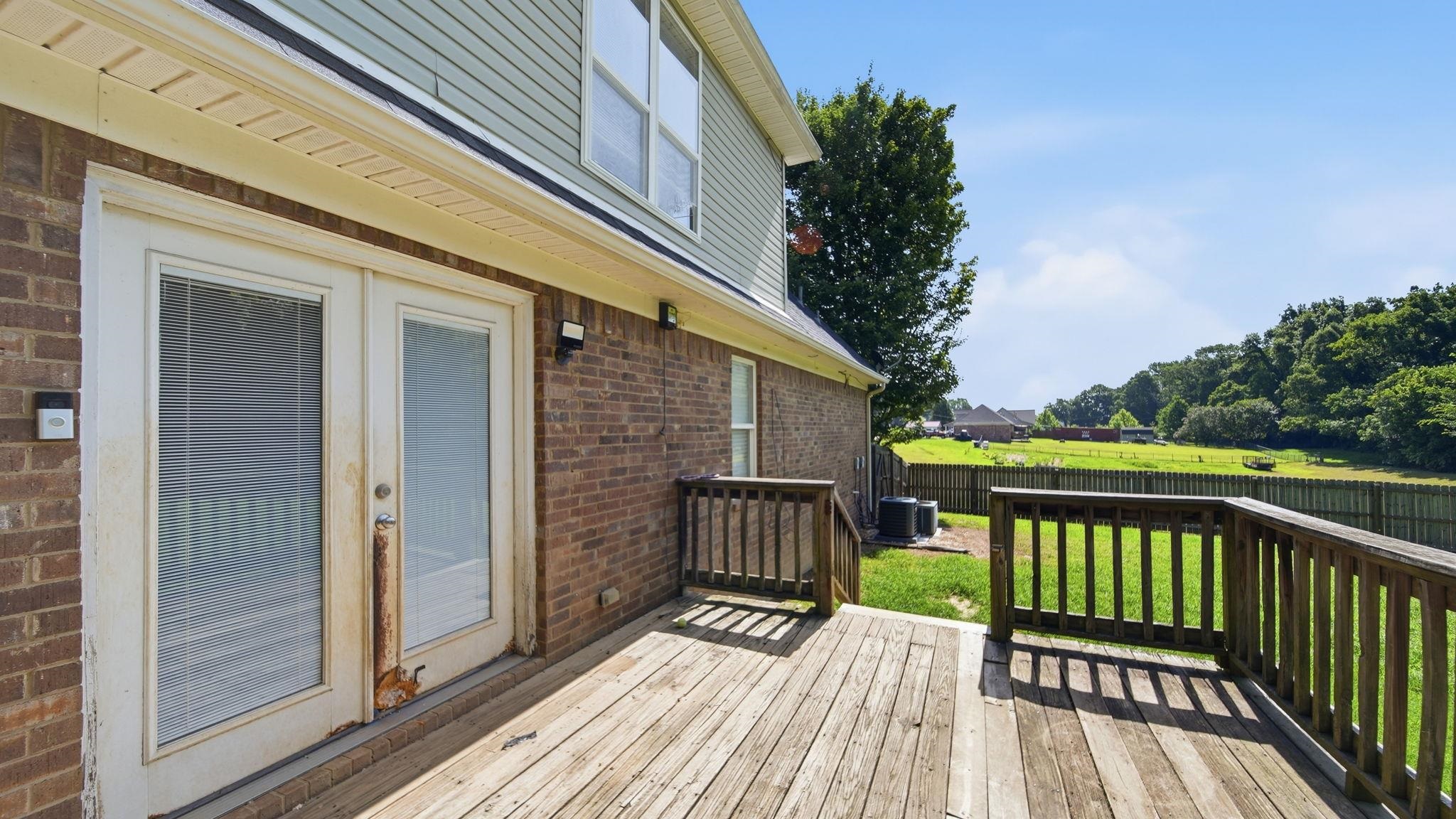 217 Rae Drive Munford, TN 38058 - Photo 35 of 40 Expansive wood deck with wood railings, double patio doors, and brick exterior