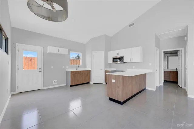 a living room with stainless steel appliances kitchen island furniture and a kitchen view