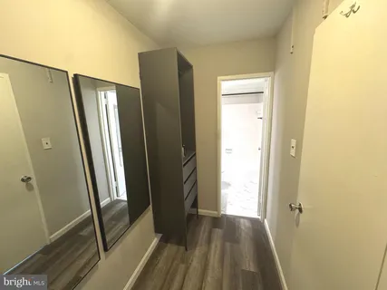 a view of a hallway with wooden floor