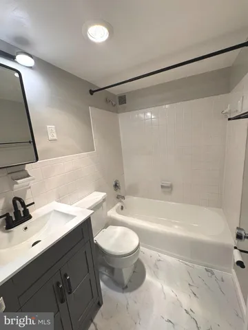 a bathroom with a sink a toilet and a bathtub
