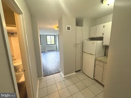 a view of a hallway to rooms