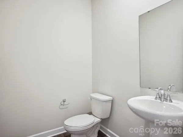 a white toilet sitting next to a bathroom sink