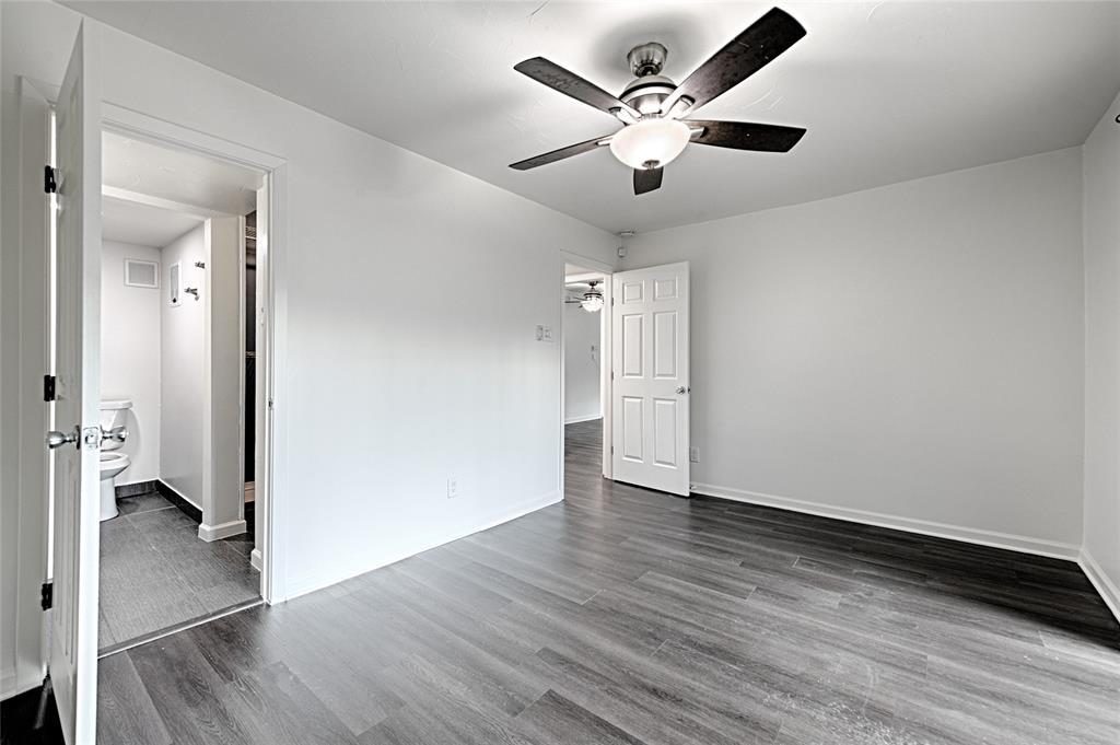 4561 North O'Connor Road, Unit 1292 Irving, TX 75062 - Photo 7 of 10 Spacious room featuring wood-finish flooring, white walls, and a ceiling fan with integrated lighting