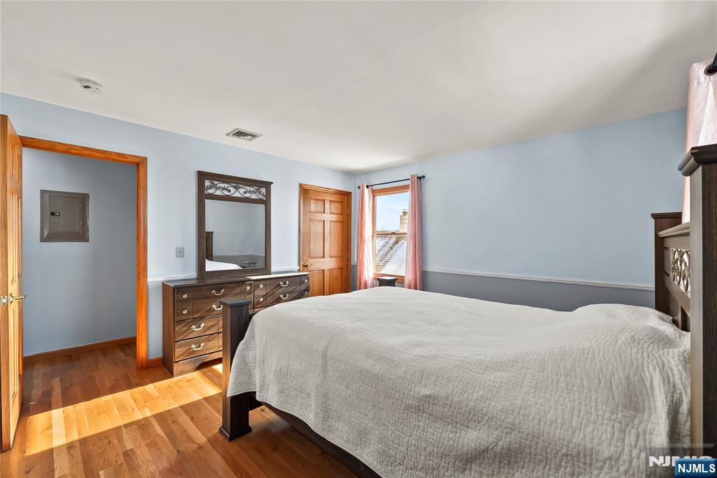 391 Taylor, Unit 2 Hackensack, NJ 07601 - Photo 10 of 15 a spacious bedroom with a bed and wooden floor