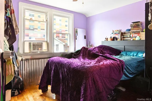 a bedroom with two bed and a flat screen tv