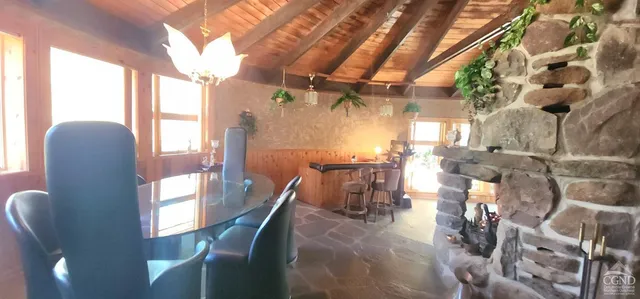 a view of a dining room with furniture and chandelier
